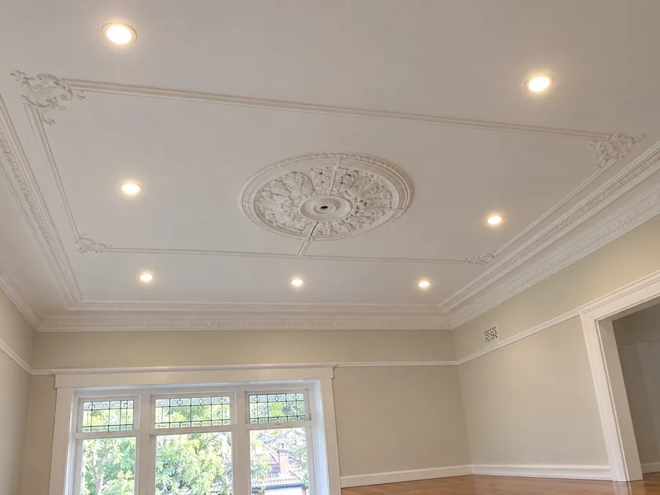 Recessed LED downlights in ornate plaster ceiling of a beige living room in Pennant Hills